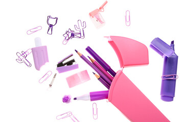 Flying pencil case with different stationery on white background