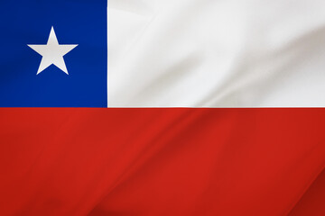 Chile flag on waving silk background. Fabric texture. National icon of Chile.