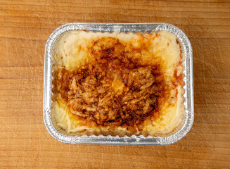 Lasagna portion in aluminium foil tray isolated. Oven baked lasagne for heating, container, airplane food