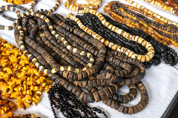 Amber stones market, polished orange gemstones closeup, natural Baltic amber gems jewelry store