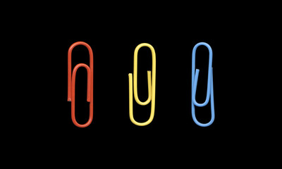 Set of Three Colorful Paper Clips on Black Background