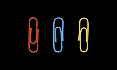 Set of Three Colorful Paper Clips on Black Background