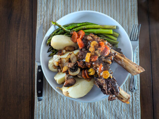 Gourmet Braised Beef Short Ribs with Asparagus and Potatoes Served on White Dish