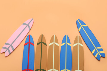 Different mini surfboards on orange background