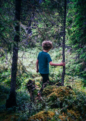 A young child Adventurer walks through the lush Swedish wilderness, discovering nature while surrounded by tall pine trees and vibrant greenery, embracing the natural beauty of the outdoors.