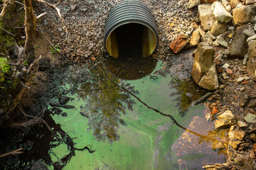 Toxic waste flows out through the sewer pipe.Water pollution by waste from the enterprise.An...
