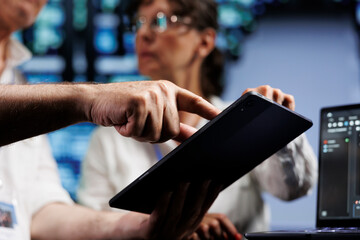 Technical support consultants running analysis on rackmounts used for managing databases, hosting...