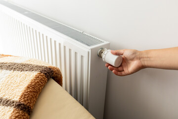 modern radiator for heating in the apartment with power regulators. ideal for those costs of heating and utilities in winter,  person regulates the level of heat