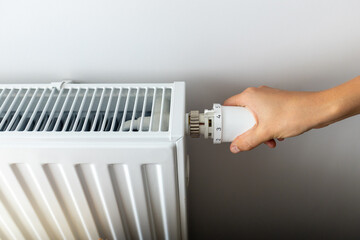 modern radiator for heating in the apartment with power regulators. ideal for those costs of heating and utilities in winter, person regulates the level of heat