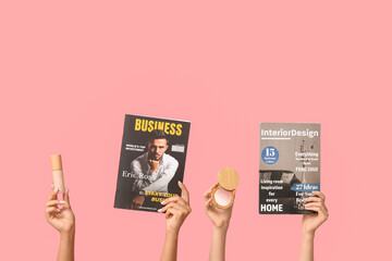 Female hands with different magazines and decorative cosmetics on pink background