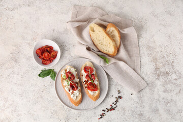 Plate of tasty tomato bruschetta with ricotta and peppercorn on white background