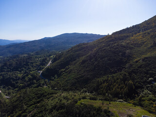 Naklejka premium Beautiful and scenic aerial view of village of Gerês, Soajo, Portugal. Spring day. City, houses, mountains and waterfalls. Near Porto. Drone.