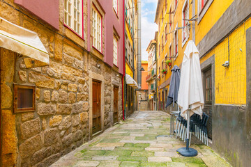 The narrow, colorful hillside alleys and streets full of shops, cafes and restaurants in the historic Ribeira district of Porto Portugal.