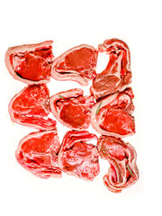 Nine fresh lamb loin chops on white background. Fine premium quality meat product uncooked juicy surface and herb. Butcher craft and skill.