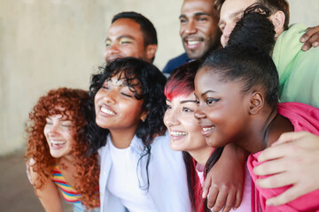 Young group of people smiling, celebrating together. Happy multi-ethnic friends community having fun outside