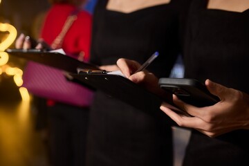 Woman in stylish dress with chic manicure using smartphone in closeup shot