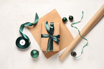 Christmas gift box with packing materials and decorations on white background