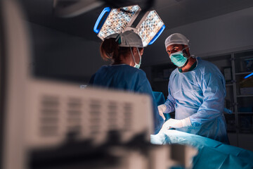 Professional surgeons in action, carefully performing an operation.