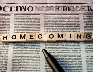The word 'Homecoming' is written in letters on top of a newspaper