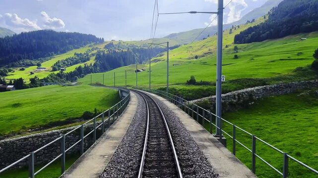 Glacier Express Train Point of View on Railroad Tracks and Mountainscape and Mountain Valley in a Sunny Summer Day in Sedrun, Surselva, Oberalp, Grisons, Switzerland, Europe