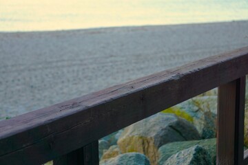 Drewniane ogrodzenie i widoczne morze w oddali. Morze Bałtyckie widoczne w tle. © Adam