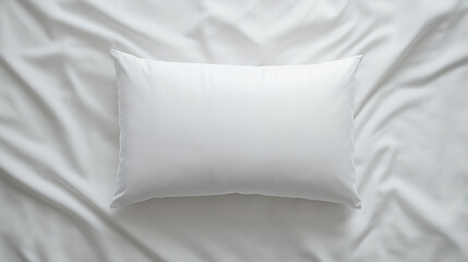 good sleep and morning concept: top-down view of a soft, rectangular white pillow on smooth white sheets
