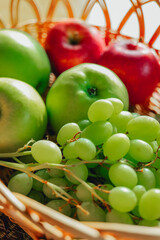 Grapes and green apples in basket on table . Healthy fruit snack. delicious and healthy dietary vegetarian snack. 