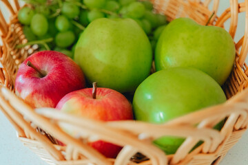 Grapes and green apples in basket.basket fruits.Healthy fruit snack. delicious and healthy dietary vegetarian snack. 
