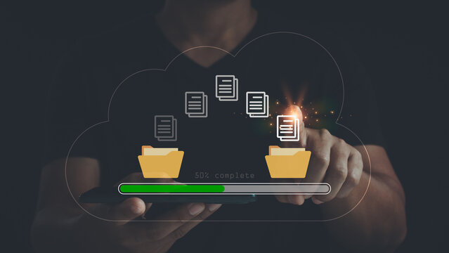 Transfer files data system relocation concept. backup copy files, migration, data exchange. Person hand using laptop computer waiting for transfer file process with loading bar icon on virtual screen.