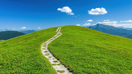 Fototapeta premium scenic pathway winds through lush green hills under bright blue sky.