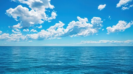 Calm Ocean Under Bright Blue Sky with Clouds