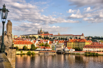 Fototapeta premium Prague, Czech Republic - July 19, 2024: Early morning views of the Vltava River and the Charles Bridge in Prague in the Czech Republic 