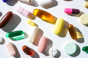 A lot of colorful medication pills capsules tablets softgel supplements, fish oil, vitamin, omega 3