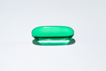 Vitamin E softgel capsules, vitamin D3, fish oil, omega 3, Green oil pills on a white background