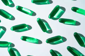 Vitamin E softgel capsules, vitamin D3, fish oil, omega 3, Green oil pills on a white background