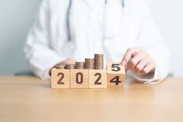 2024 end year to Happy New Year 2025 with Doctor and coins stack. Money stack Counting arrangement for deposit, Healthcare cost, Money Saving, Health Insurance, Medical, Donation and Financial concept