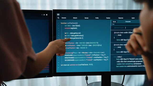 Slow motion back end software developer engineer for computer programming working together on debugging writing computing code, solving complex algorithms display on monitor in office. Burgeoning