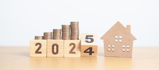 2024 end year to Happy New Year 2025 with house model and Coins stack. real estate, Home loan, tax,...