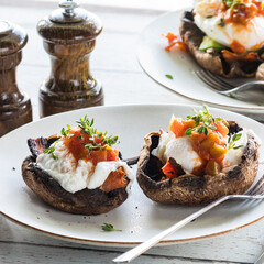 Portobello mushroom eggs Benedict on a plate, ready for eating.