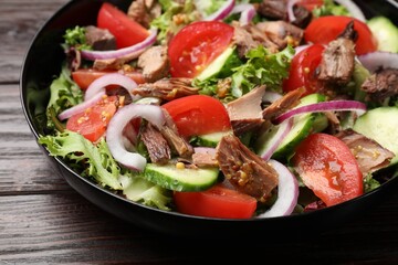 Delicious fresh tuna salad on wooden table, closeup