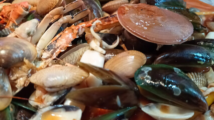 Close up of various seafood dishes with crab and shells