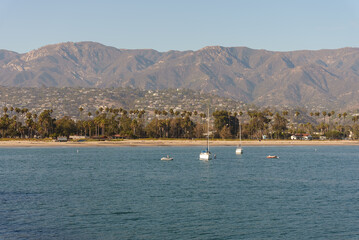 Water body with mountains behind and boats in front