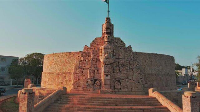 This video showcases the Monument to the Heroes of the Caste War, located in the city of Campeche, Mexico. The monument is a large, stone structure that features intricate carvings depicting various