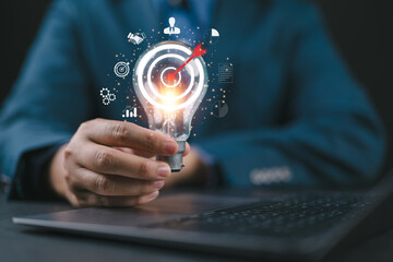 Man hand holding lightbulb with learning educate which for mind, creative, idea, innovation, motivation planning development leadership and customer target group concept.