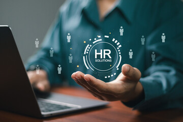 HR Solutions concept. Businessman using laptop with human resources solutions icons for human resources management tool used to manage employee information in organization.