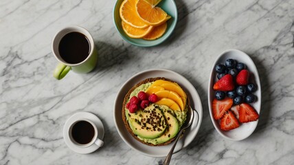 A delicious and colorful breakfast spread featuring healthy avocado toast, fresh fruit, and coffee on a marble table