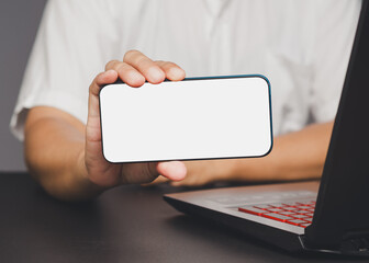 Man holding smartphone with blank screen.