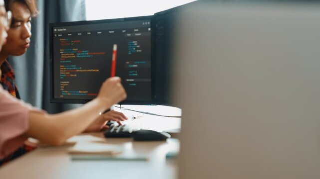 Slow motion back end software developer engineer for computer programming working together on debugging writing computing code, solving complex algorithms display on monitor in office. Burgeoning