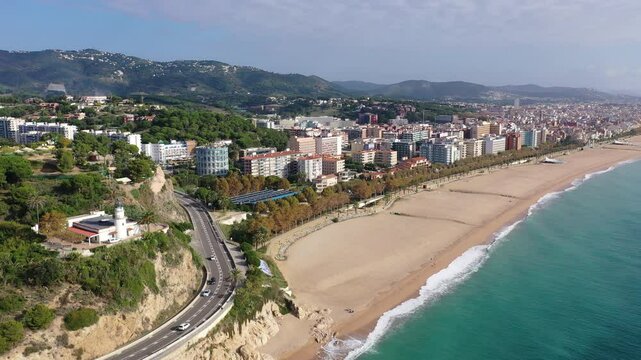 Birds eye view of Calella, Spain. Residential building along Mediterranean sea coast and beach visible from above.