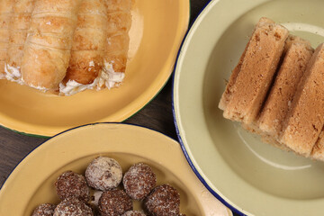 Bangladesh Indian cone shaped hard flaky puff pastry stuffed cream roll Indian Milk Cake Alwar Ka Mawa dry flaky biscuit like sweet treat traditional  Narkel Naru Coconut ladoo laddu with Jaggery